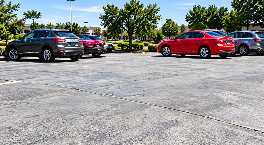 Level concrete parking lot with parked cars